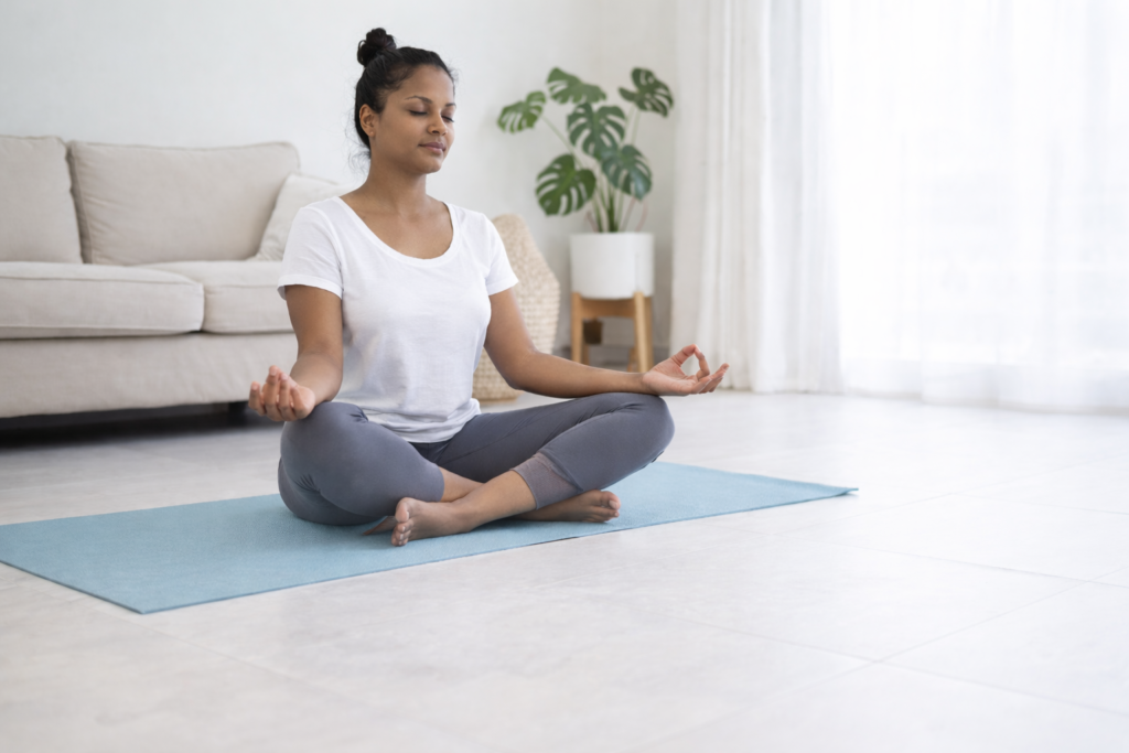 Woman practicing meditation yoga at home for stress relief and better sleep